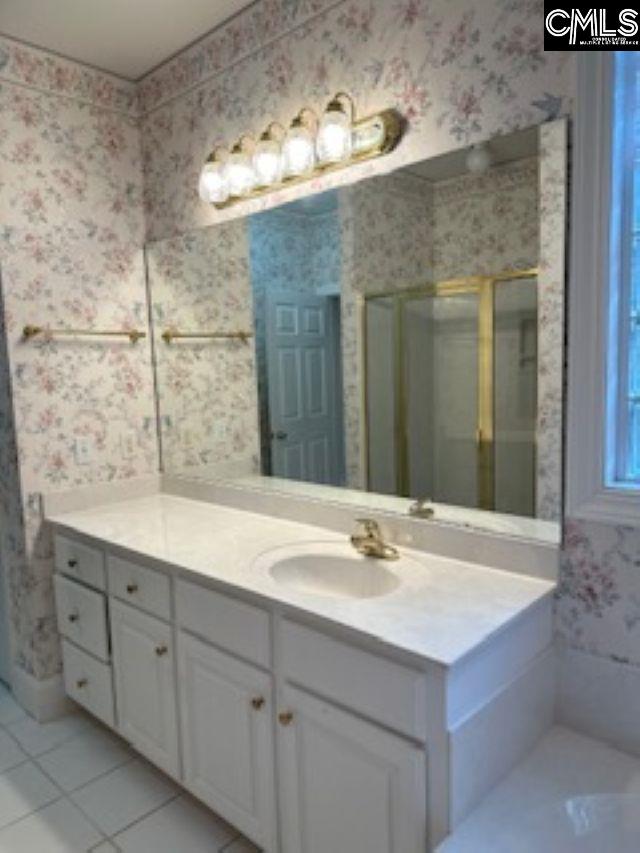 117 York Commons, Lexington, SC 29072 - full bath with wallpapered walls, a shower stall, vanity, and tile patterned floors