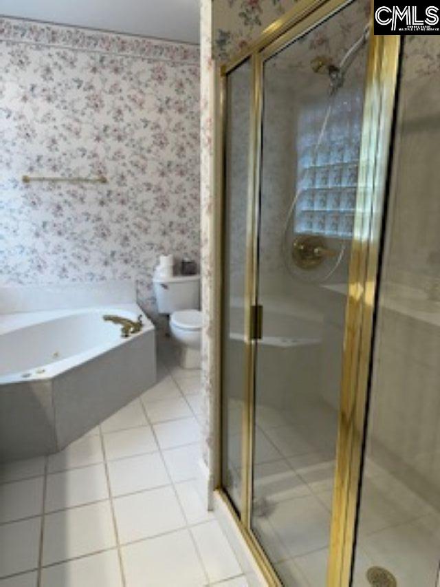 117 York Commons, Lexington, SC 29072 - bathroom with wallpapered walls, tile patterned flooring, toilet, a bath, and a stall shower