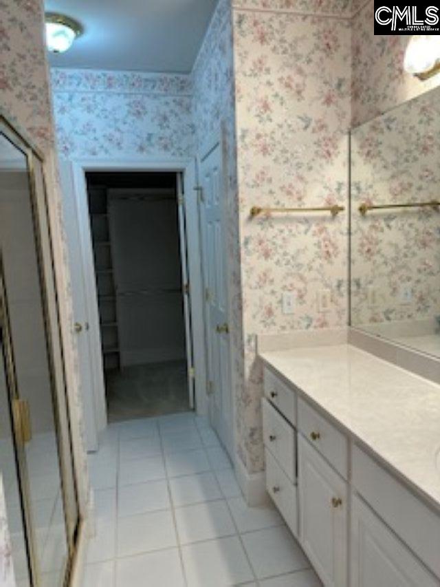 117 York Commons, Lexington, SC 29072 - bathroom featuring wallpapered walls, vanity, tile patterned flooring, and a stall shower