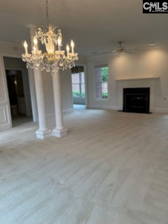 117 York Commons, Lexington, SC 29072 - unfurnished living room featuring carpet floors, ornamental molding, a fireplace with flush hearth, a chandelier, and baseboards