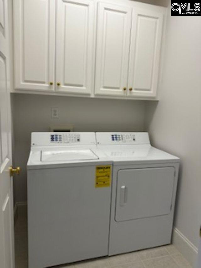 117 York Commons, Lexington, SC 29072 - laundry area featuring washer and clothes dryer, cabinet space, baseboards, and light tile patterned floors