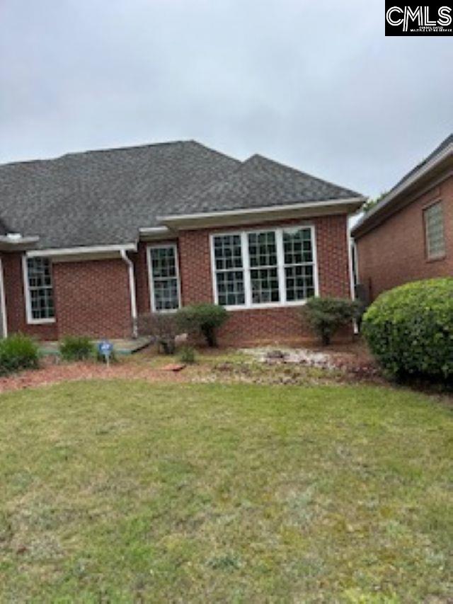117 York Commons, Lexington, SC 29072 - view of front of home with brick siding, a front yard, and roof with shingles
