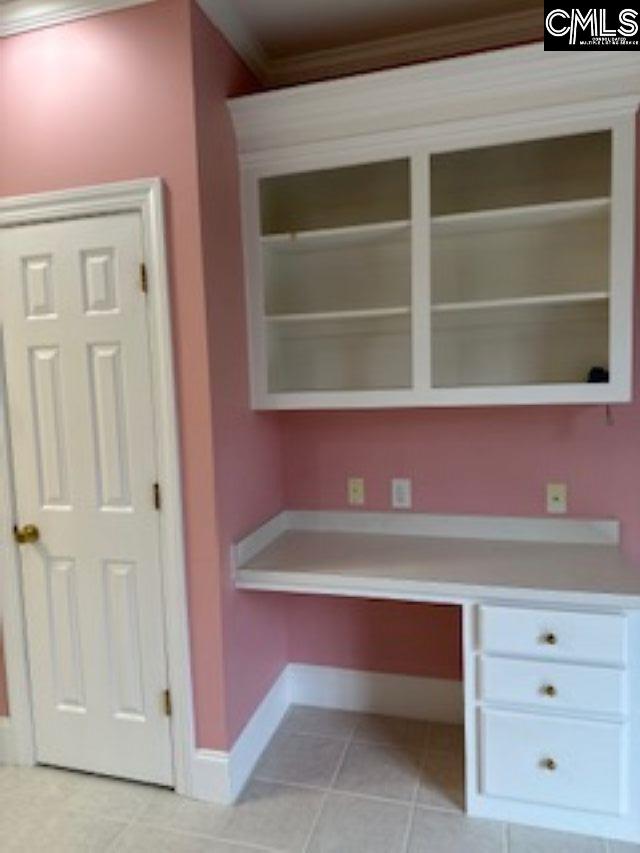 117 York Commons, Lexington, SC 29072 - unfurnished office featuring built in desk, baseboards, crown molding, and light tile patterned floors