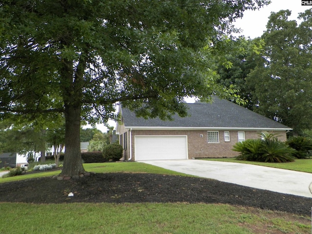 217 Tattlers Trl, Irmo, SC 29063 - view of side of home featuring concrete driveway, an attached garage, brick siding, and a lawn
