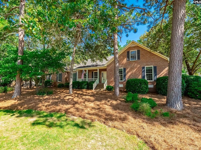 117 Falmouth Rise Rd, Columbia, SC 29229 - view of front of home featuring brick siding, a porch, and a front lawn