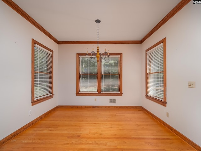 117 Falmouth Rise Rd, Columbia, SC 29229 - unfurnished dining area featuring a chandelier, baseboards, light wood finished floors, and crown molding
