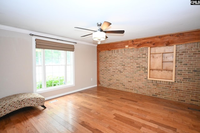2110 Bouknight St, Newberry, SC 29108 - unfurnished room featuring light wood-style floors, brick wall, baseboards, ceiling fan, and crown molding
