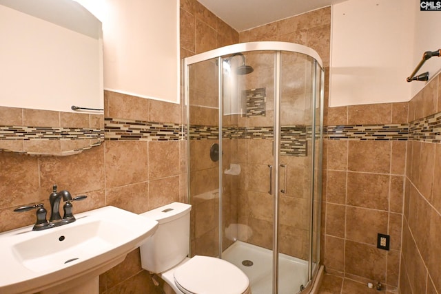 2110 Bouknight St, Newberry, SC 29108 - full bath featuring tile walls, a stall shower, a sink, toilet, and a wainscoted wall