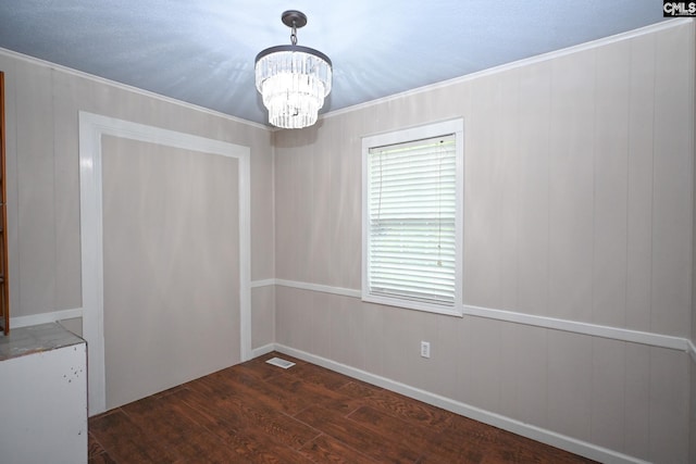 2110 Bouknight St, Newberry, SC 29108 - empty room featuring wood finished floors, a chandelier, and ornamental molding