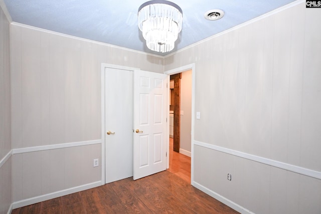 2110 Bouknight St, Newberry, SC 29108 - unfurnished bedroom featuring a chandelier, wood finished floors, ornamental molding, and baseboards
