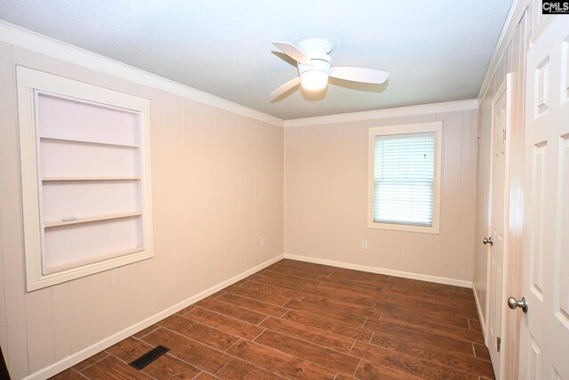 2110 Bouknight St, Newberry, SC 29108 - empty room featuring ornamental molding, dark wood-style flooring, baseboards, ceiling fan, and built in features