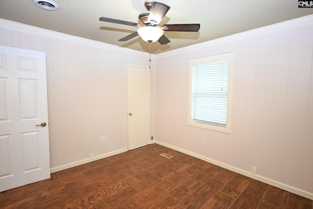 2110 Bouknight St, Newberry, SC 29108 - spare room featuring crown molding, dark wood-type flooring, a ceiling fan, and baseboards