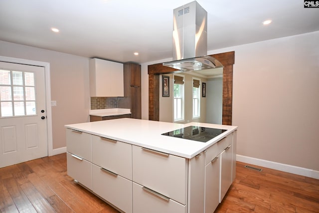 2110 Bouknight St, Newberry, SC 29108 - kitchen featuring island range hood, black electric cooktop, modern cabinets, white cabinets, and light wood-style flooring
