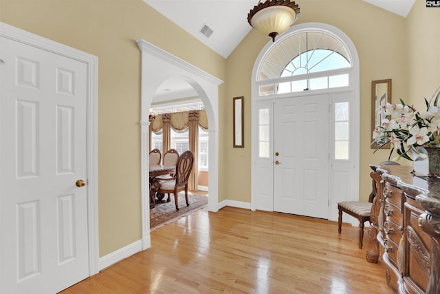 175 Stoney Pointe Dr, Chapin, SC 29036 - foyer featuring arched walkways, vaulted ceiling, healthy amount of natural light, light wood-style floors, and baseboards