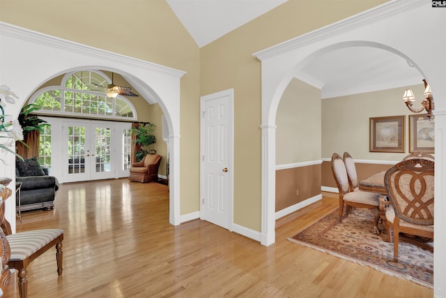 175 Stoney Pointe Dr, Chapin, SC 29036 - living area featuring light wood-style flooring, arched walkways, french doors, high vaulted ceiling, and a chandelier