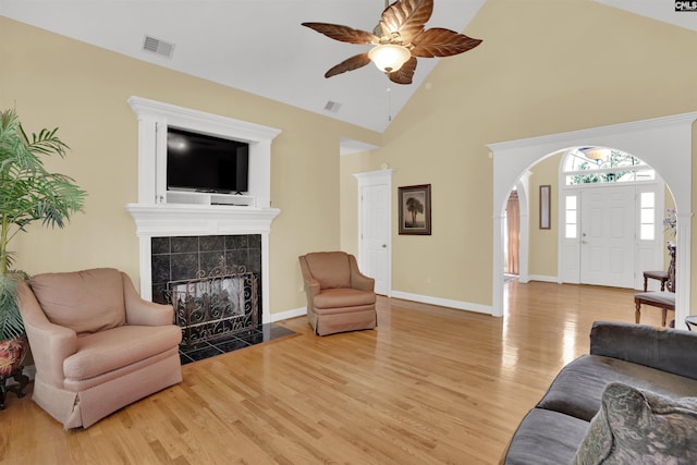 175 Stoney Pointe Dr, Chapin, SC 29036 - living area featuring light wood-style floors, a ceiling fan, arched walkways, a fireplace, and baseboards