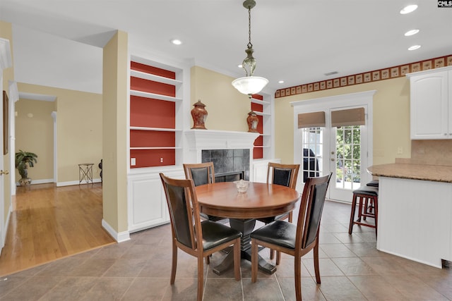 175 Stoney Pointe Dr, Chapin, SC 29036 - dining space with built in shelves, a fireplace, recessed lighting, baseboards, and light tile patterned floors