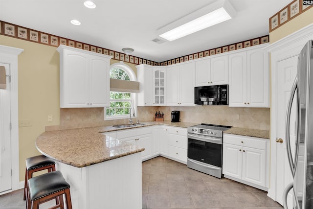 175 Stoney Pointe Dr, Chapin, SC 29036 - kitchen with stainless steel appliances, a sink, a peninsula, a kitchen breakfast bar, and white cabinets