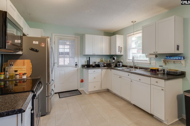 1921 Cunningham Rd, Columbia, SC 29210 - kitchen with range with electric cooktop, a sink, dark countertops, white cabinetry, and a textured ceiling