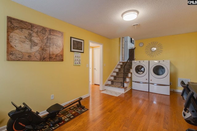 1921 Cunningham Rd, Columbia, SC 29210 - laundry room featuring washing machine and clothes dryer, wood finished floors, a textured ceiling, and baseboards