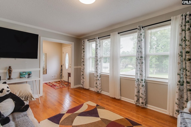 1921 Cunningham Rd, Columbia, SC 29210 - foyer entrance with light wood finished floors, healthy amount of natural light, crown molding, baseboards, and a textured ceiling