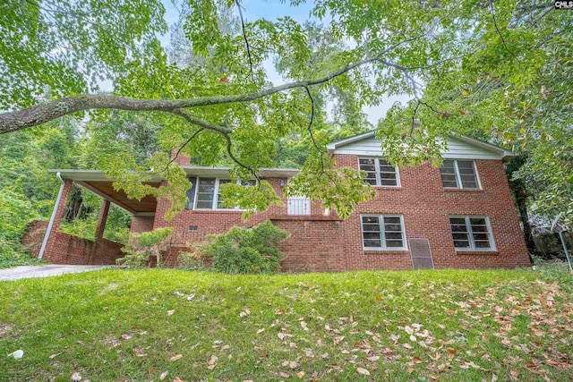 1669 Upland Dr, Columbia, SC 29204 - view of side of home featuring a yard, brick siding, and a carport