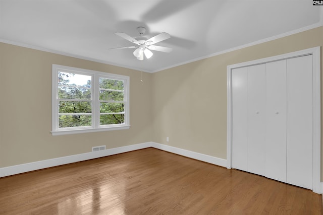 1669 Upland Dr, Columbia, SC 29204 - unfurnished bedroom with wood finished floors, baseboards, ornamental molding, a closet, and ceiling fan