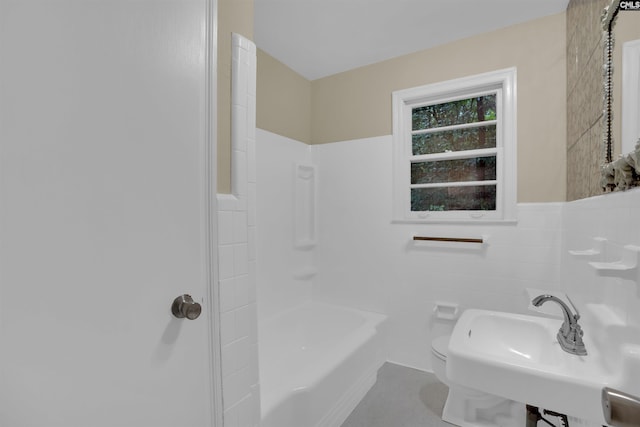 1669 Upland Dr, Columbia, SC 29204 - full bathroom featuring toilet, tile walls, wainscoting, a sink, and washtub / shower combination