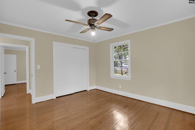 1669 Upland Dr, Columbia, SC 29204 - unfurnished bedroom with light wood-style flooring, baseboards, crown molding, a closet, and a ceiling fan