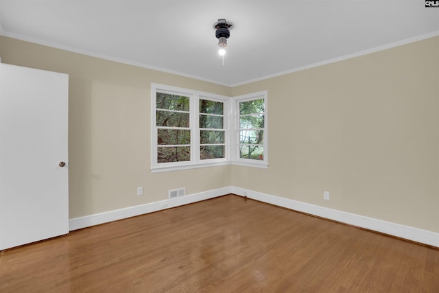 1669 Upland Dr, Columbia, SC 29204 - empty room with wood finished floors, baseboards, and ornamental molding