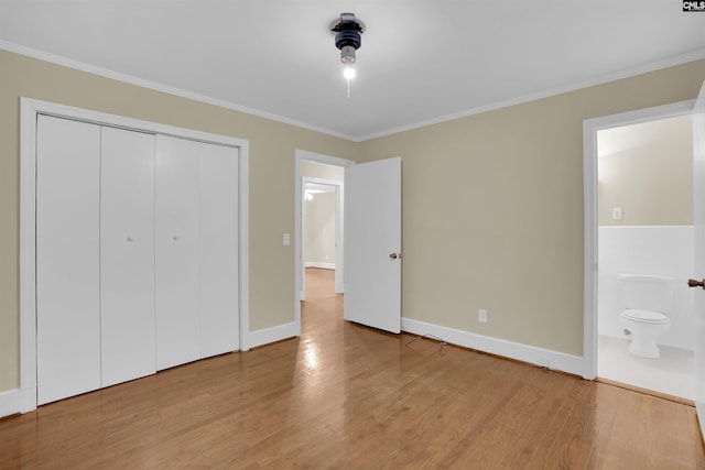 1669 Upland Dr, Columbia, SC 29204 - unfurnished bedroom with wood finished floors, crown molding, baseboards, a closet, and ensuite bath