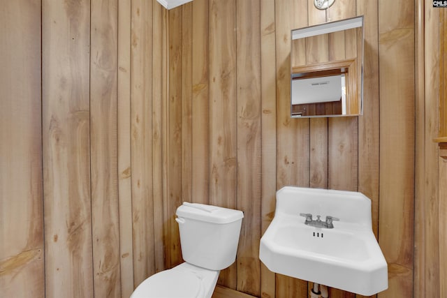 1669 Upland Dr, Columbia, SC 29204 - half bath with wooden walls, toilet, and a sink