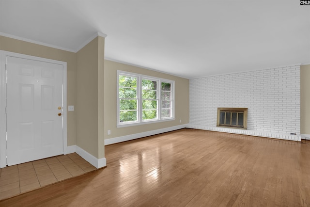 1669 Upland Dr, Columbia, SC 29204 - unfurnished living room featuring wood finished floors, baseboards, ornamental molding, and a brick fireplace