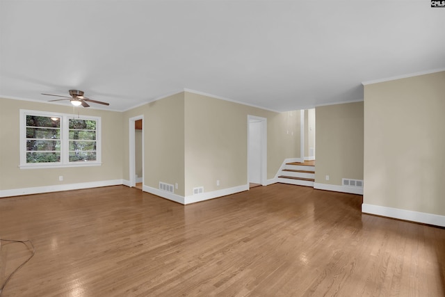 1669 Upland Dr, Columbia, SC 29204 - spare room with a ceiling fan, wood finished floors, stairs, baseboards, and crown molding