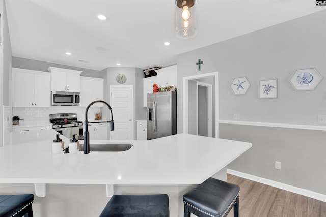 1051 Ashcroft Cir, Columbia, SC 29229 - kitchen with stainless steel appliances, a kitchen breakfast bar, tasteful backsplash, a sink, and recessed lighting