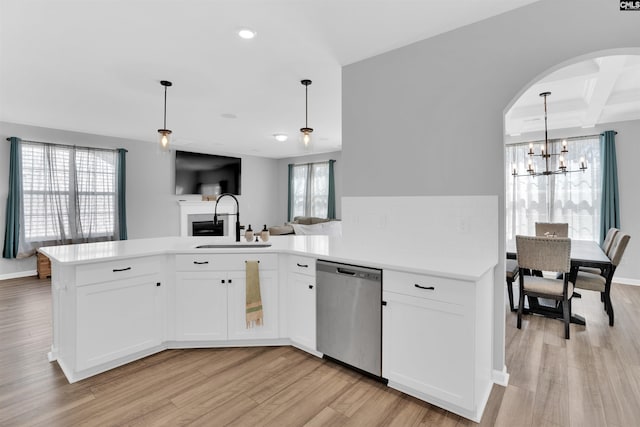 1051 Ashcroft Cir, Columbia, SC 29229 - kitchen featuring dishwasher, a sink, arched walkways, light wood-style floors, and light countertops