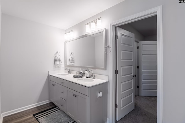 1051 Ashcroft Cir, Columbia, SC 29229 - bathroom with double vanity, baseboards, and wood finished floors
