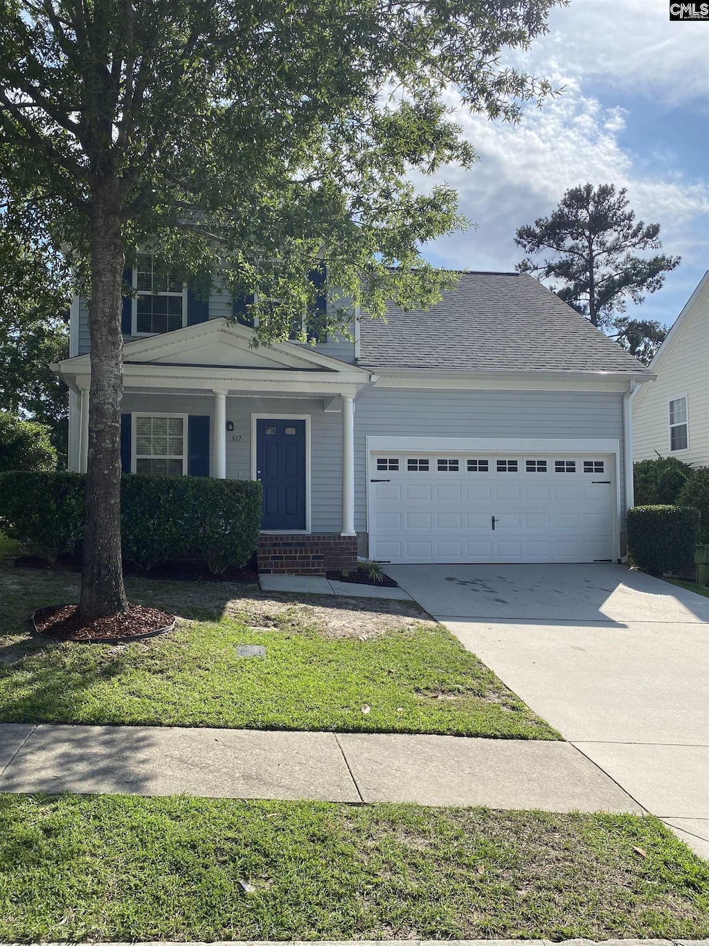 317 Denman Loop, Columbia, SC 29229 - view of front of home featuring an attached garage, concrete driveway, a front lawn, and a porch