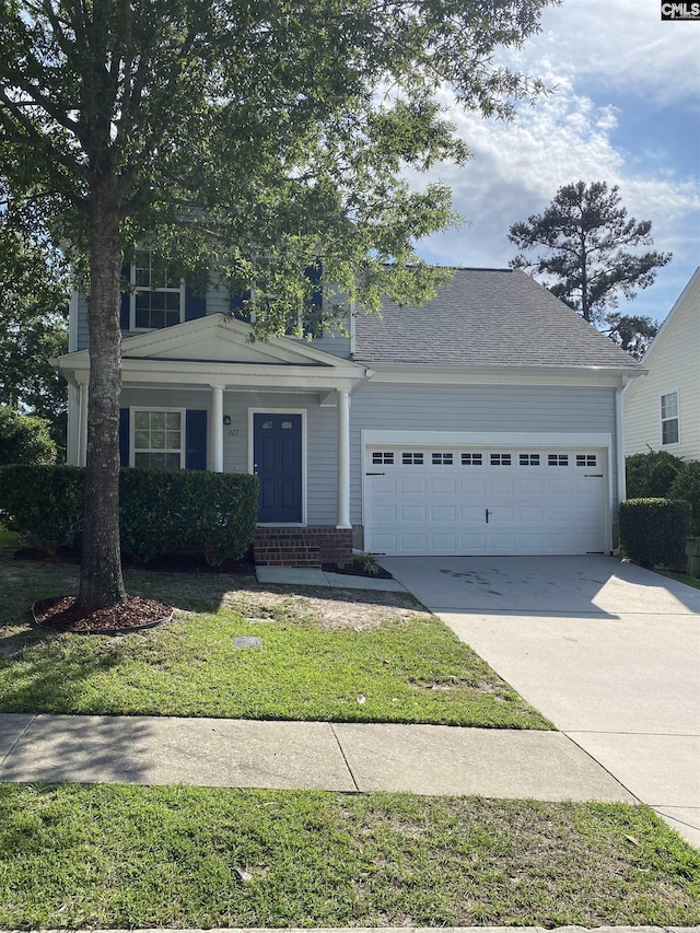 317 Denman Loop, Columbia, SC 29229 - view of front of home featuring an attached garage, concrete driveway, a front lawn, and a porch