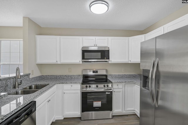 414 Fountain Lk, Columbia, SC 29209 - kitchen with stainless steel appliances, a sink, dark wood-style flooring, white cabinets, and a textured ceiling