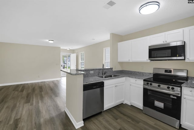 414 Fountain Lk, Columbia, SC 29209 - kitchen with appliances with stainless steel finishes, a sink, dark wood-type flooring, a peninsula, and white cabinets