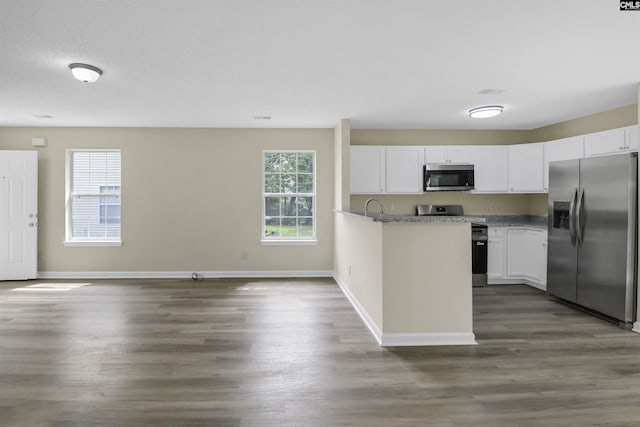 414 Fountain Lk, Columbia, SC 29209 - kitchen with appliances with stainless steel finishes, white cabinets, baseboards, and dark wood-style flooring