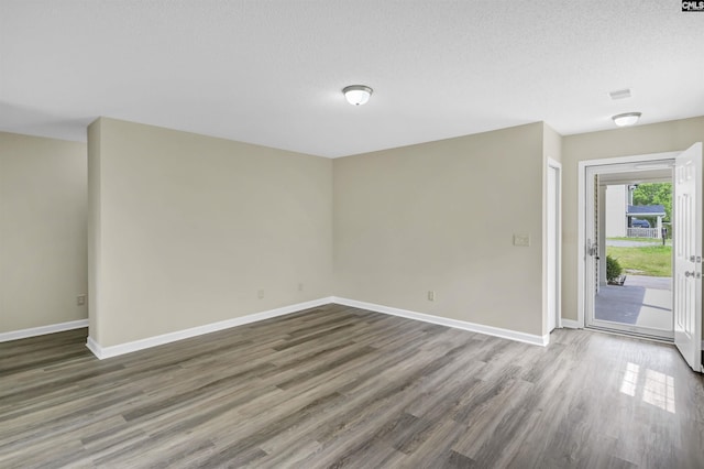 414 Fountain Lk, Columbia, SC 29209 - unfurnished room with wood finished floors, baseboards, and a textured ceiling