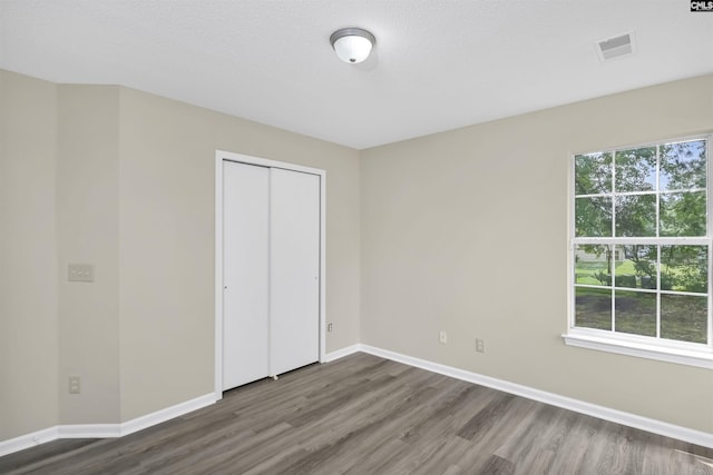 414 Fountain Lk, Columbia, SC 29209 - unfurnished bedroom featuring wood finished floors, baseboards, and a closet