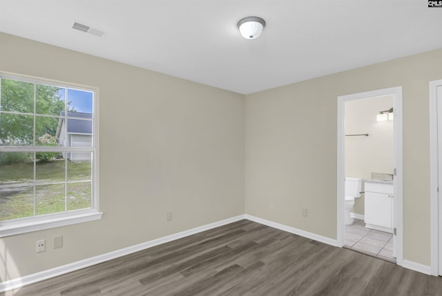 414 Fountain Lk, Columbia, SC 29209 - unfurnished bedroom with wood finished floors, baseboards, and connected bathroom