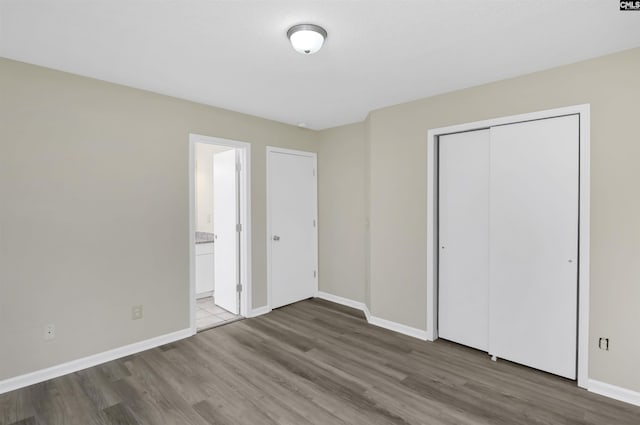 414 Fountain Lk, Columbia, SC 29209 - unfurnished bedroom featuring wood finished floors, baseboards, a closet, and ensuite bathroom