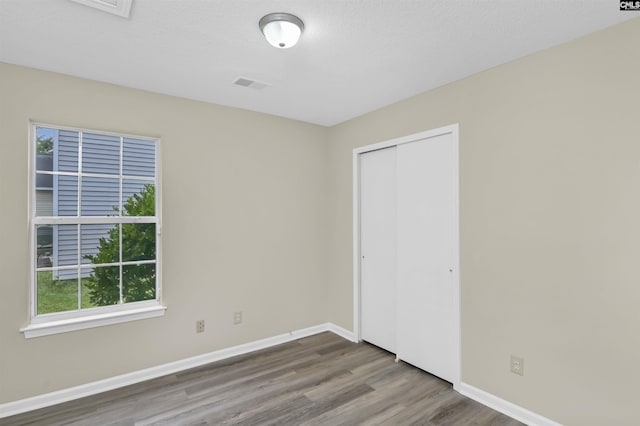 414 Fountain Lk, Columbia, SC 29209 - unfurnished bedroom with wood finished floors, baseboards, and a closet