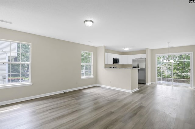 414 Fountain Lk, Columbia, SC 29209 - unfurnished living room with plenty of natural light, baseboards, and wood finished floors