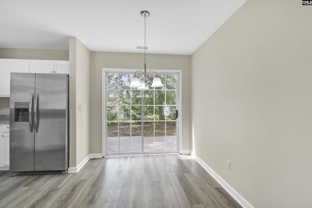 414 Fountain Lk, Columbia, SC 29209 - unfurnished dining area featuring wood finished floors, a chandelier, and baseboards