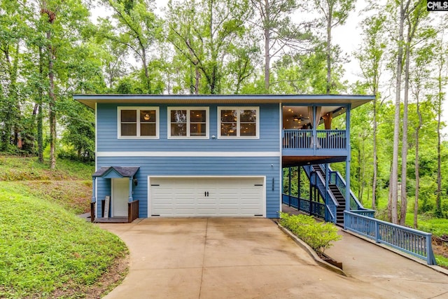 3308 Keenan Dr, Columbia, SC 29201 - view of front facade featuring a ceiling fan, stairs, a garage, and concrete driveway